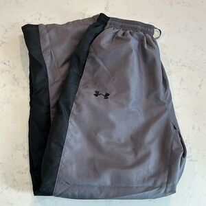 Under Armour pants. Gray with black stripe. Zippered ankles. Size large.